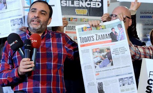 Today's Zaman Editor-in-Chief Bulent Kenes was taken from his office and arrested on charges of insulting President Recep Tayyip Erdogan in a series of tweets that the journalist said was simply him expressing a critical opinion.