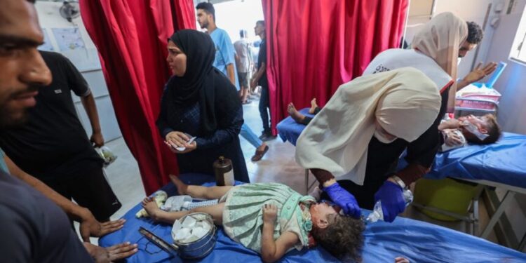 Palestinian casualties of an Israeli strike on an apartment at the Nuseirat refugee camp, receive care at Al-Awda hospital in the central Gaza Strip on July 19, 2025. (Photo by Eyad BABA / AFP)