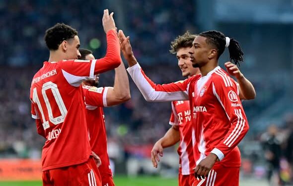 Soccer Football - Bundesliga - St. Pauli v Bayern Munich - Millerntor-Stadion, Hamburg, Germany - April 11, 2026 Bayern Munich's Michael Olise celebrates scoring their third goal with teammates REUTERS/Fabian Bimmer DFL REGULATIONS PROHIBIT ANY USE OF PHOTOGRAPHS AS IMAGE SEQUENCES AND/OR QUASI-VIDEO.