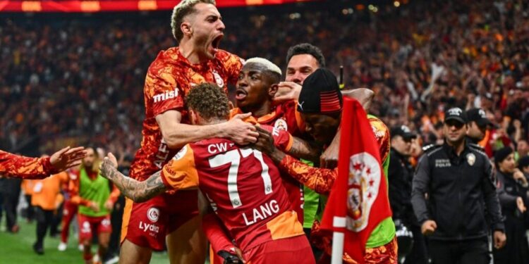 Galatasaray's Nigerian forward #45 Victor Osimhen (C) celebrates with teammates after scoring during the Turkish Super lig football match between Galatasaray and Antalyaspor at the Rams Park stadium in Istanbul, on May 9, 2026. Galatasaray clinched the Turkish Super Lig championship with one week remaining in the season. (Photo by Yasin AKGUL / AFP)