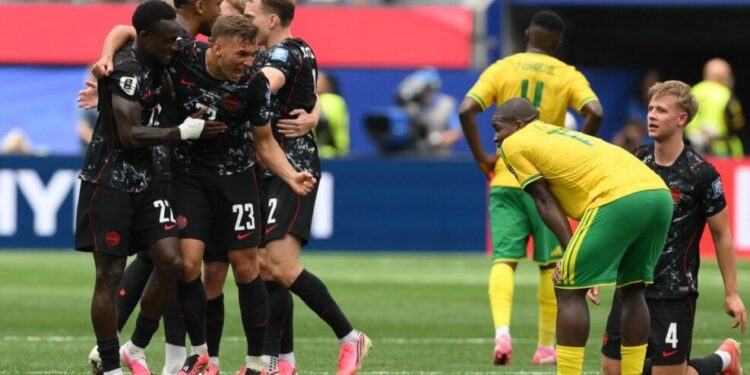 Canada's defender #22 Richie Laryea and defender #23 Niko Sigur celebrate after winning the 2026 World Cup round of 32 football match between South Africa and Canada at the Los Angeles Stadium in Inglewood on June 28, 2026.  (Photo by Patrick T. Fallon / AFP)