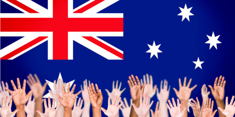 Multiethnic Arms Raised and Australian Flag Background